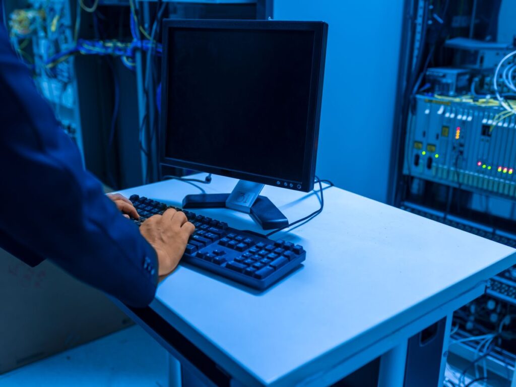 IT engineer working at a terminal in a server room